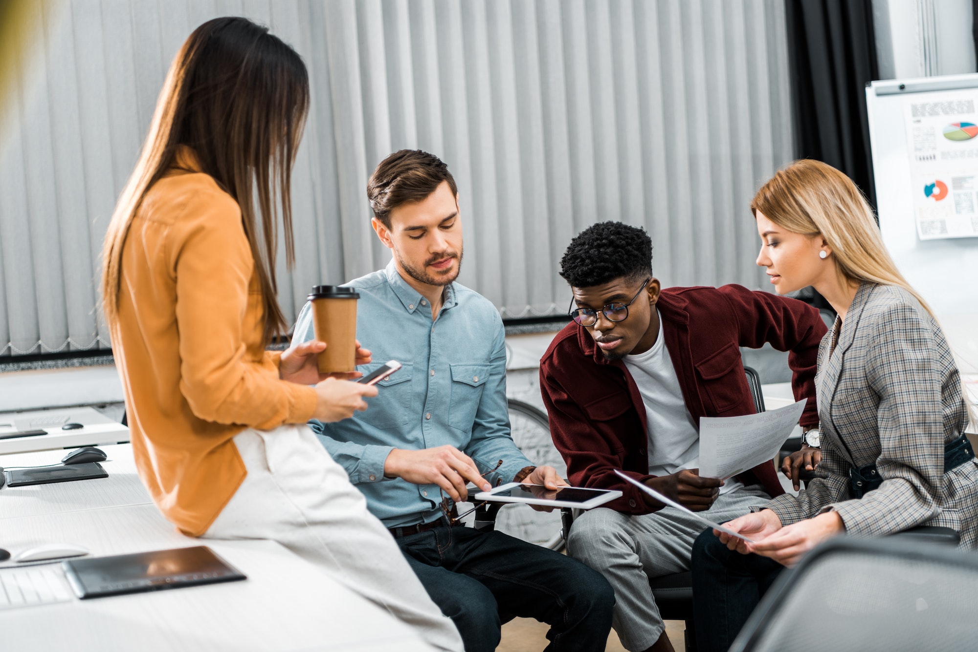 multicultural-young-businesspeople-discussing-new-business-idea-in-office.jpg