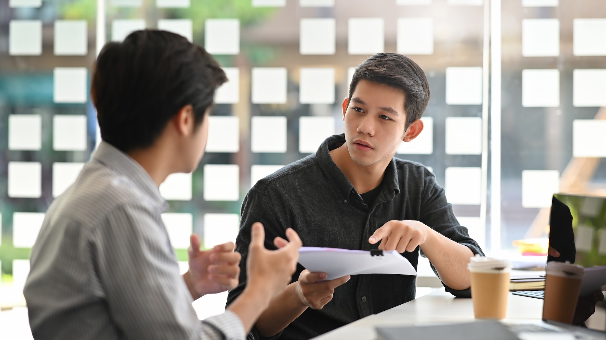 asian-young-man-consulting-with-paper-document-on-modern-office-.jpg