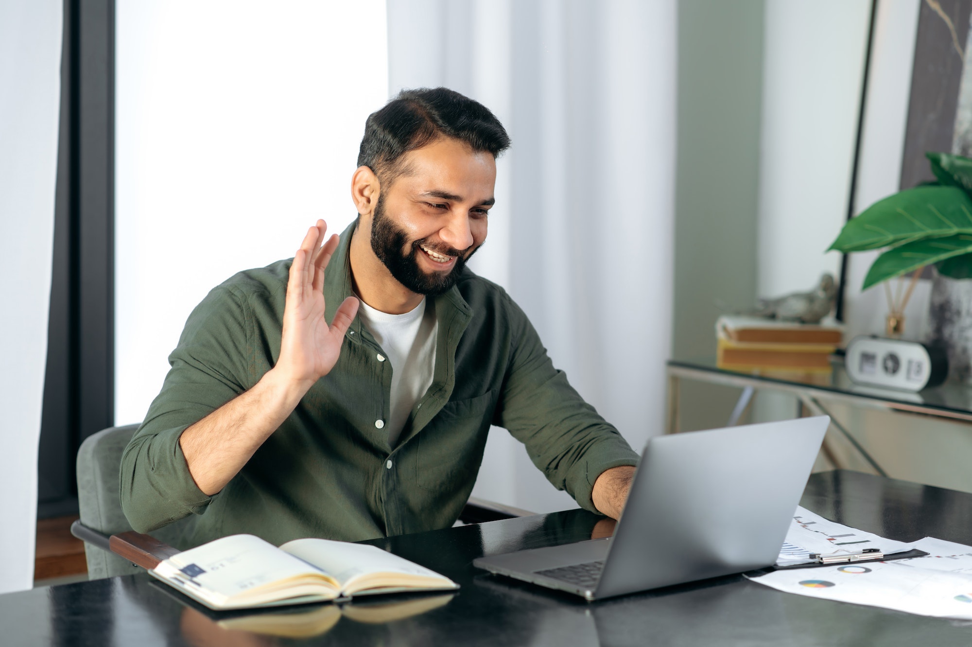 pleasant-friendly-indian-guy-manager-or-financial-consultant-communicates-with-colleagues-on-a.jpg